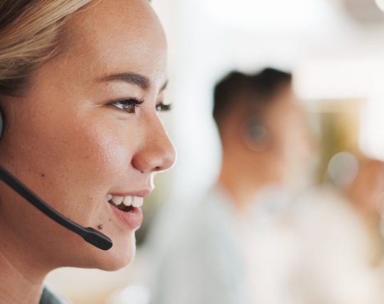Call center, consulting and smile with woman in office for contact us, communication and customer service. Salesman, help desk and technical support with person in crm agency for telemarketing mockup
